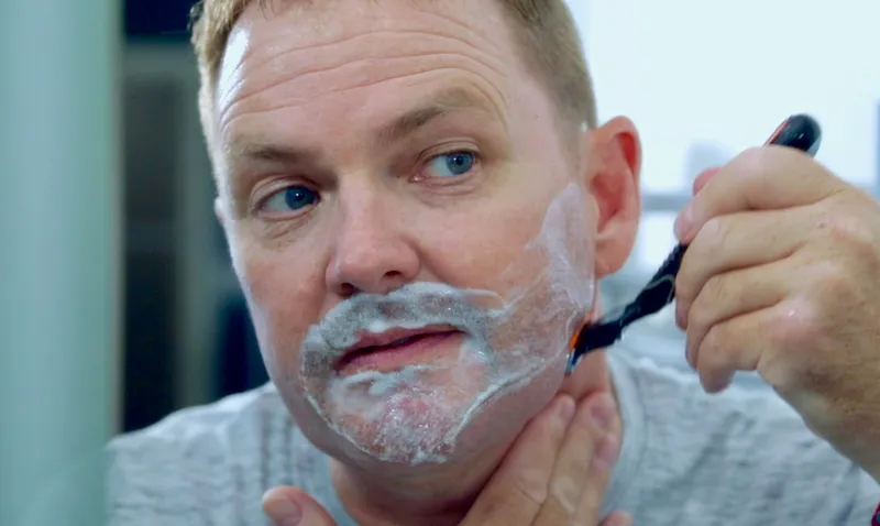 a man shaving his face